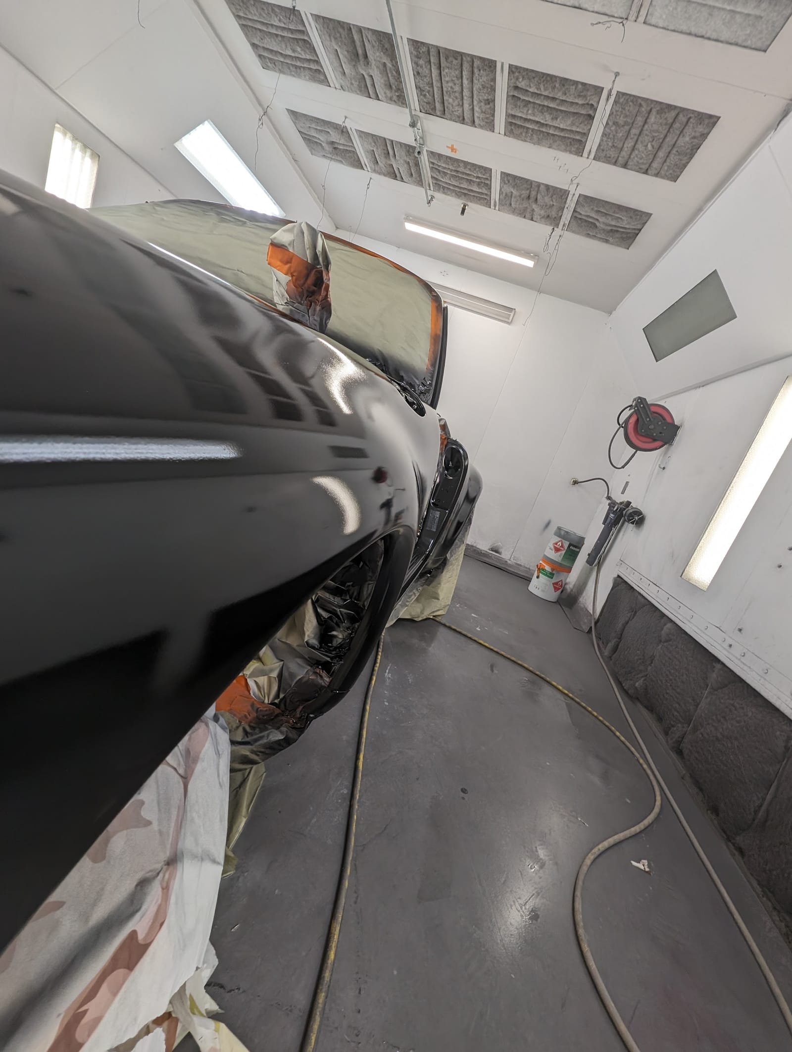 Freshly painted gloss-black truck inside the Auto Shop Repair paint booth