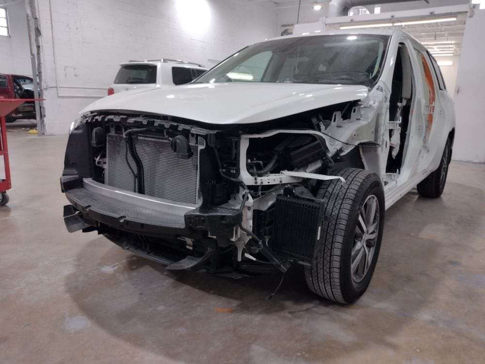 SUV with front end disassembled for collision repair at Auto Shop Repair